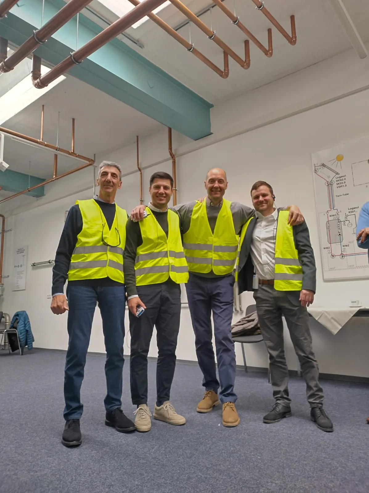 A group of SANHA® employees wearing safety waistcoats